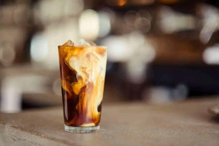 An iced latte in a glass, an example of a first product photo sent in the chat