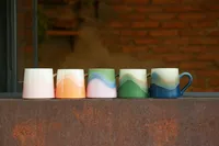 Five gradient-glazed ceramic mugs