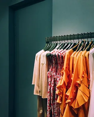 A rack of orange and pink clothes