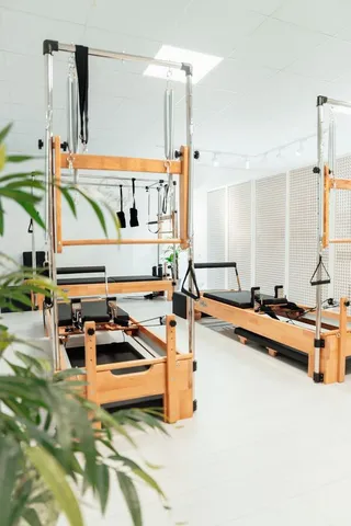 A bright Pilates studio with reformers